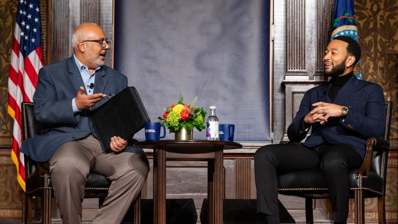 Legend speaking with Elleithee on stage in Gaston Hall