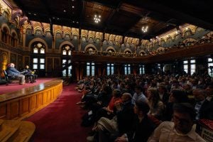 Legend and Elleithee on stage while crowd watches in Gaston Hall