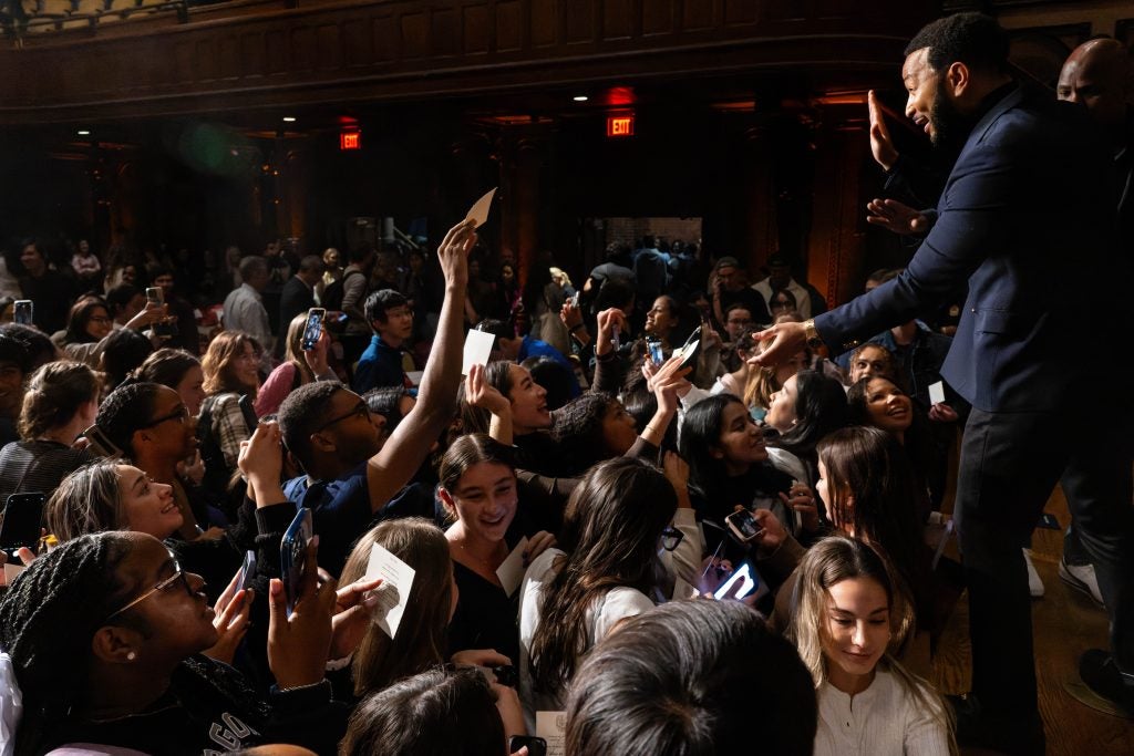 John Legend greeting students on stage