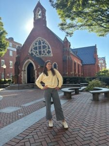 Sarah on Dahlgren quad in a long shirt and jeans