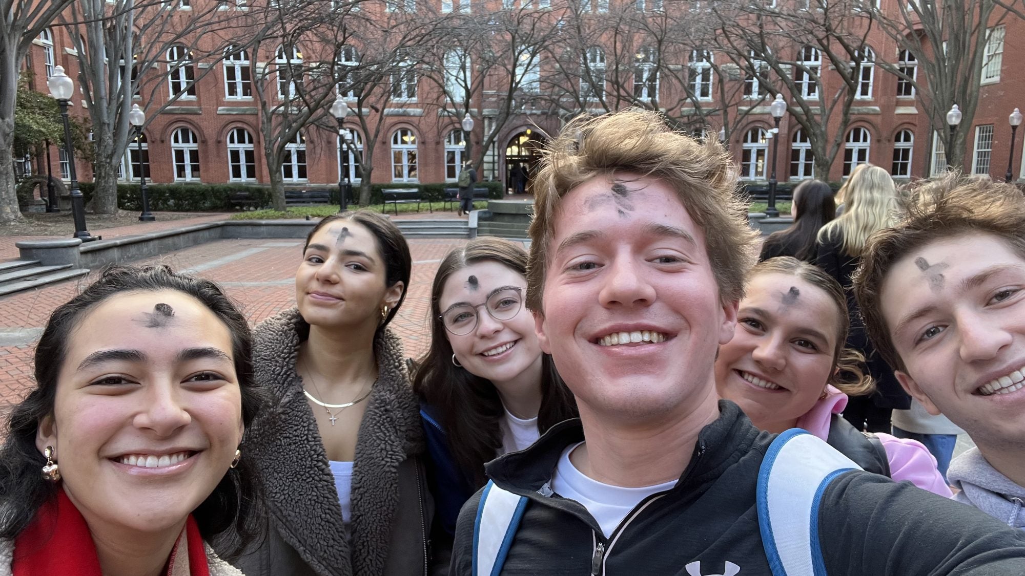 Luke and other students with ashes on foreheads for Ash Wednesday