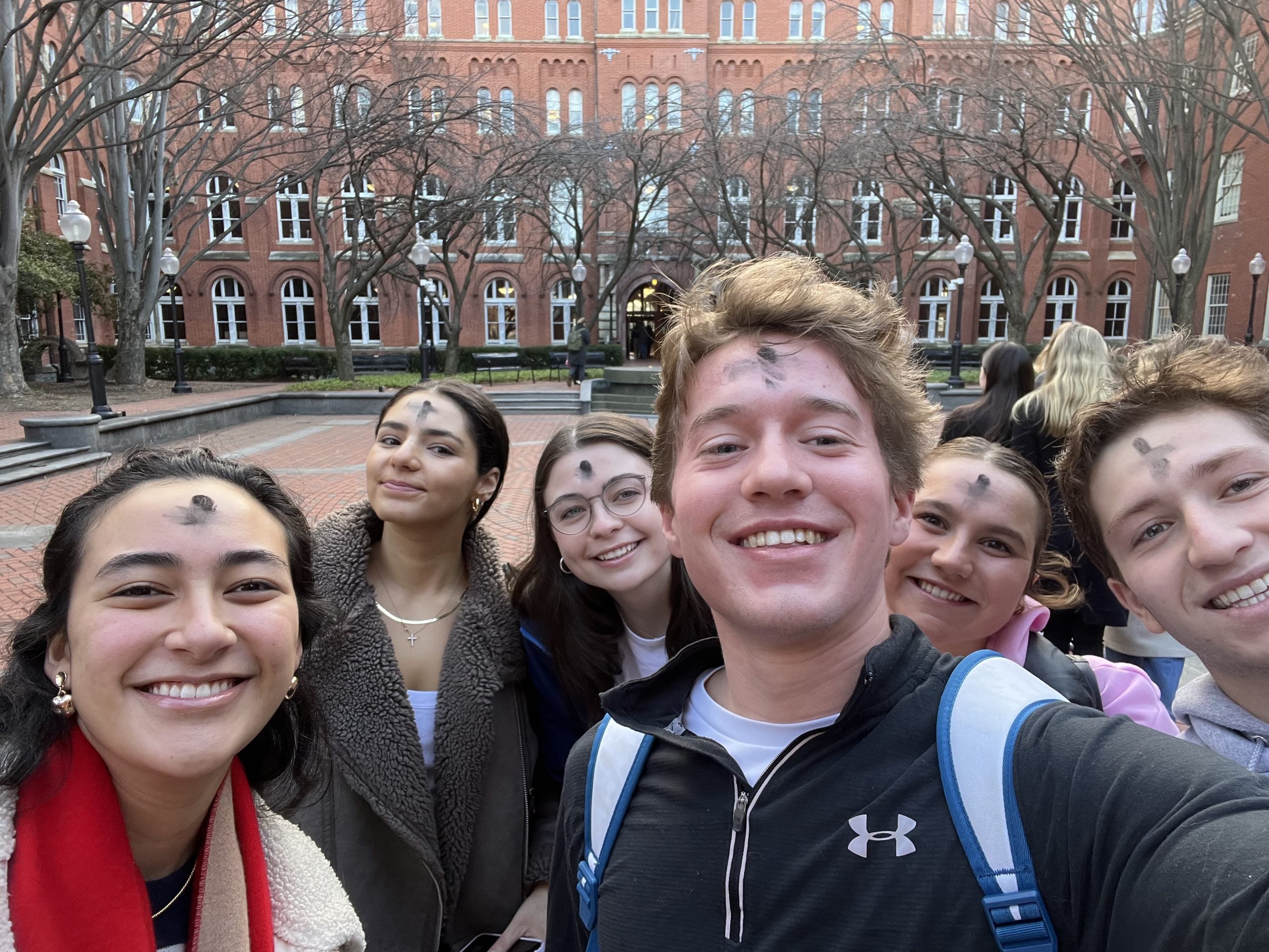 Luke and other students with ashes on foreheads for Ash Wednesday