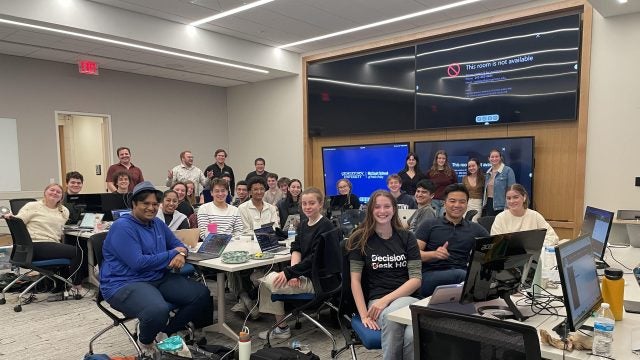 A group of students sit in a classroom.