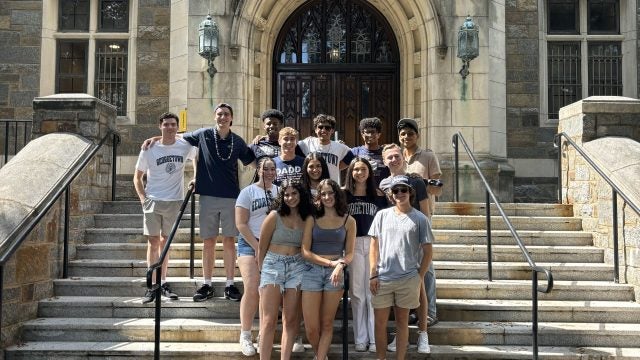 Justin Higgins with friends on the steps of Copley Hall