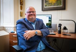 Wickman with arms crossed in his office