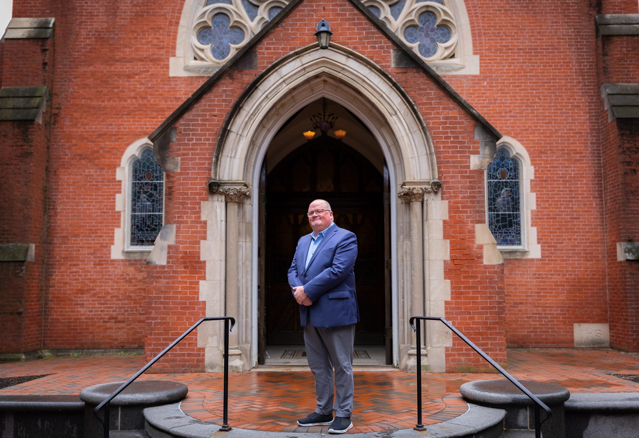 Wickman standing in front of Dahlgren Chapel