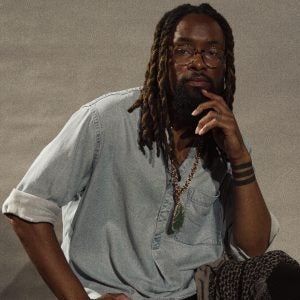 A man in a white button-down shirt and glasses.