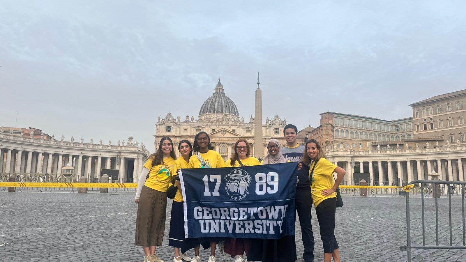 Georgetown students holding a GU Flag at the Vatican