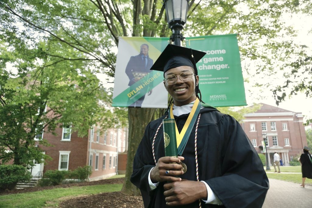 Hughes in his college graduation robes and cap