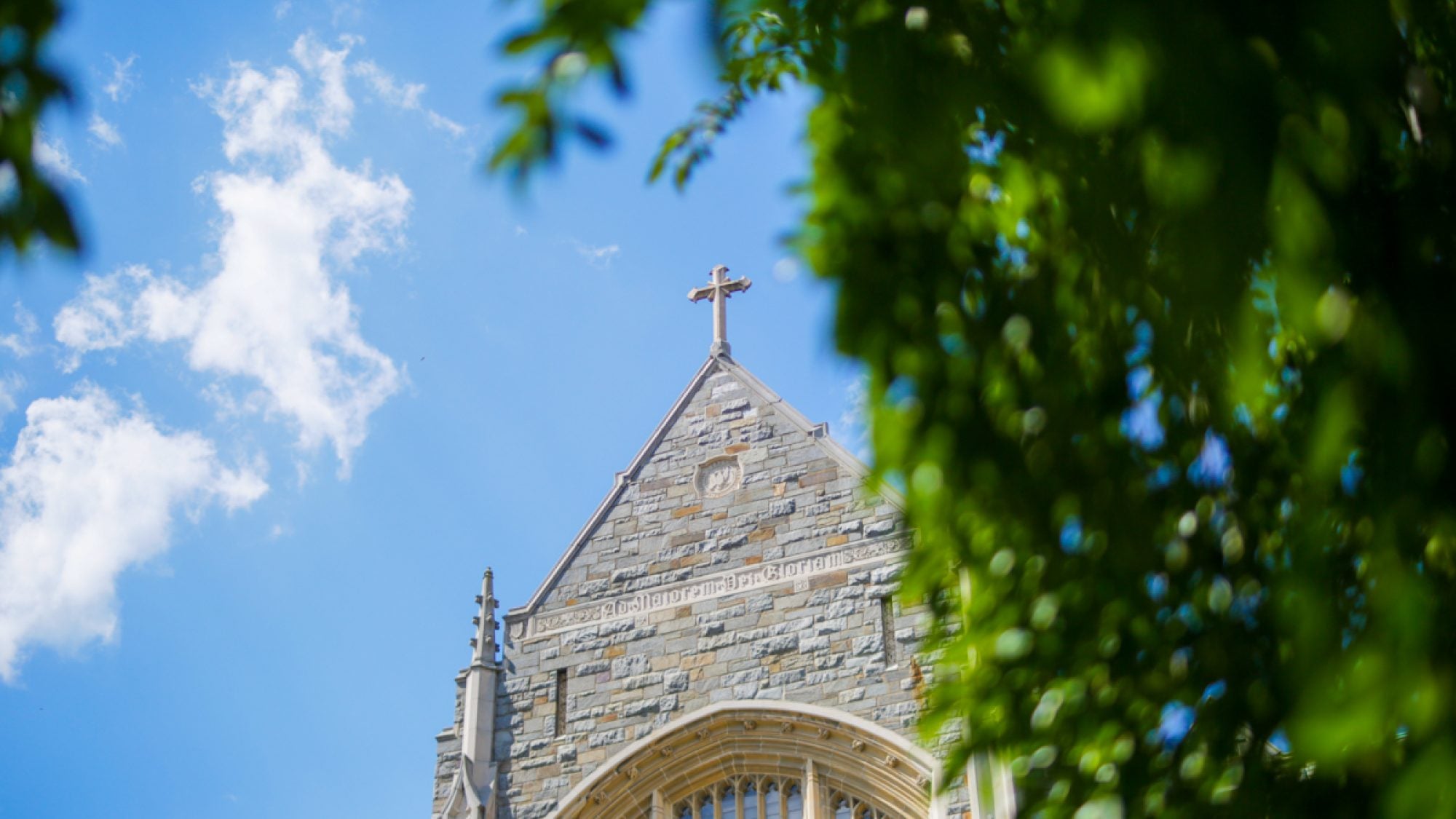 A view of a cross on a stone building on a sunny day at Georgetown.