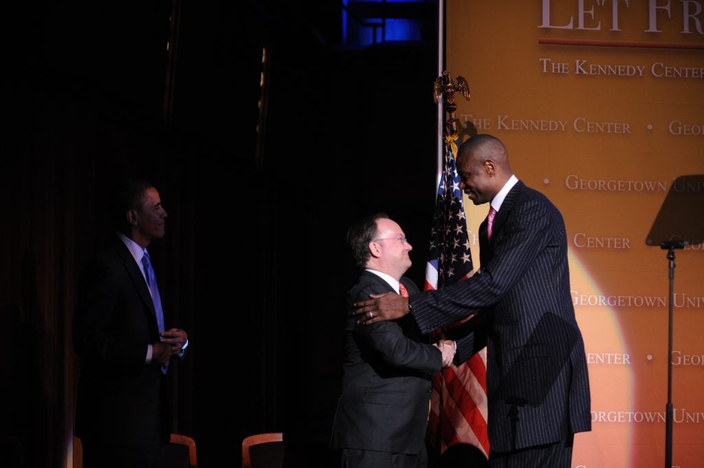 President DeGioia greets the late Dikembe Mutombo (C’91), the 2010 Legacy of a Dream recipient, with President Barack Obama.