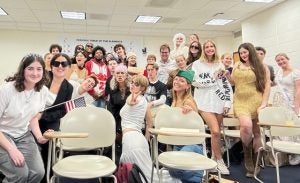 Class cohort poses for photo in costume