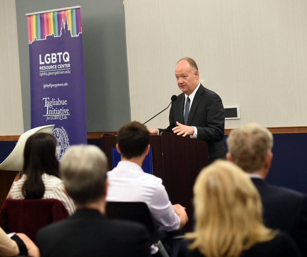 President DeGioia speaks to a crowd in front of a podium.