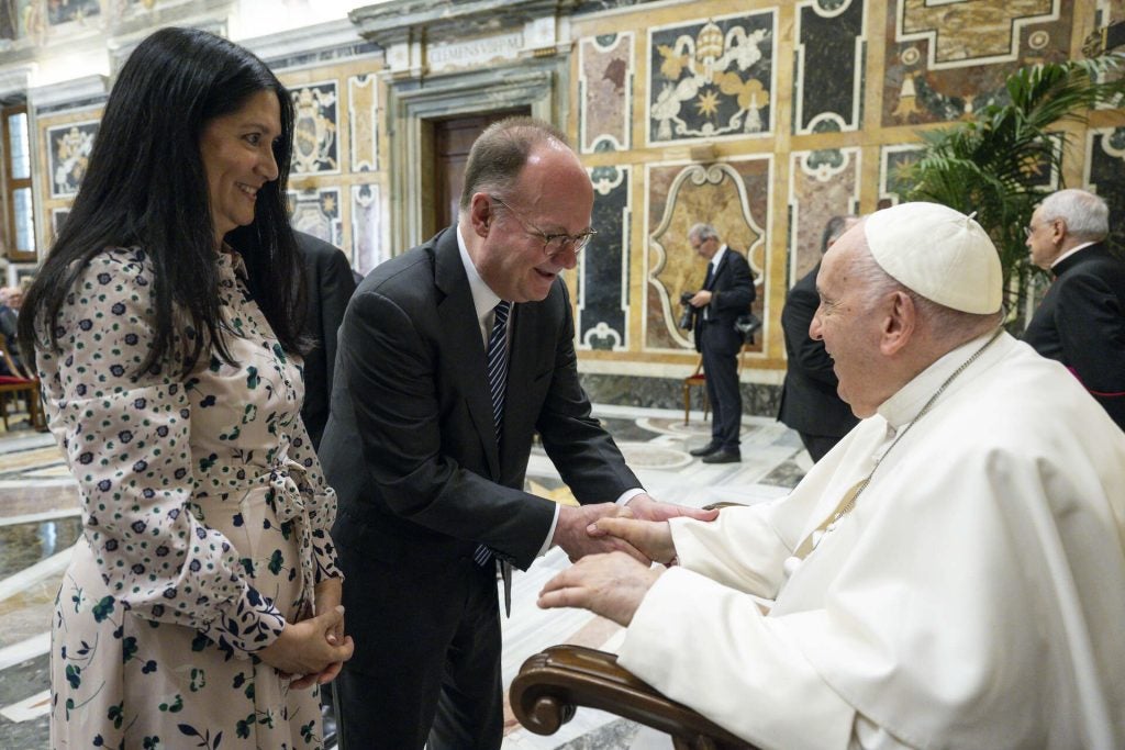 John DeGioia and his wife meet the Pope, who is seated, in the Vatican.