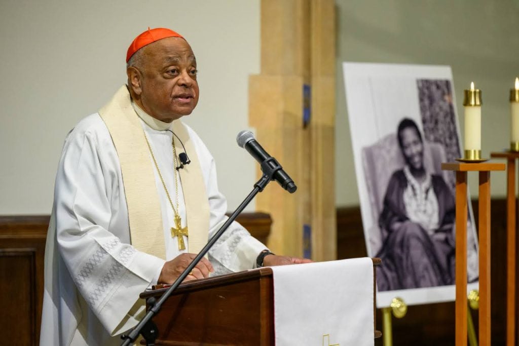 Cardinal Wilton Gregory, Archbishop of Washington, speaks in front of a podium.