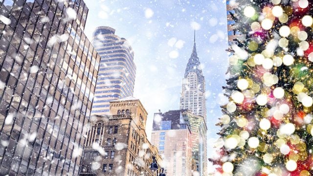 Christmas tree with a snowy New York City in the background