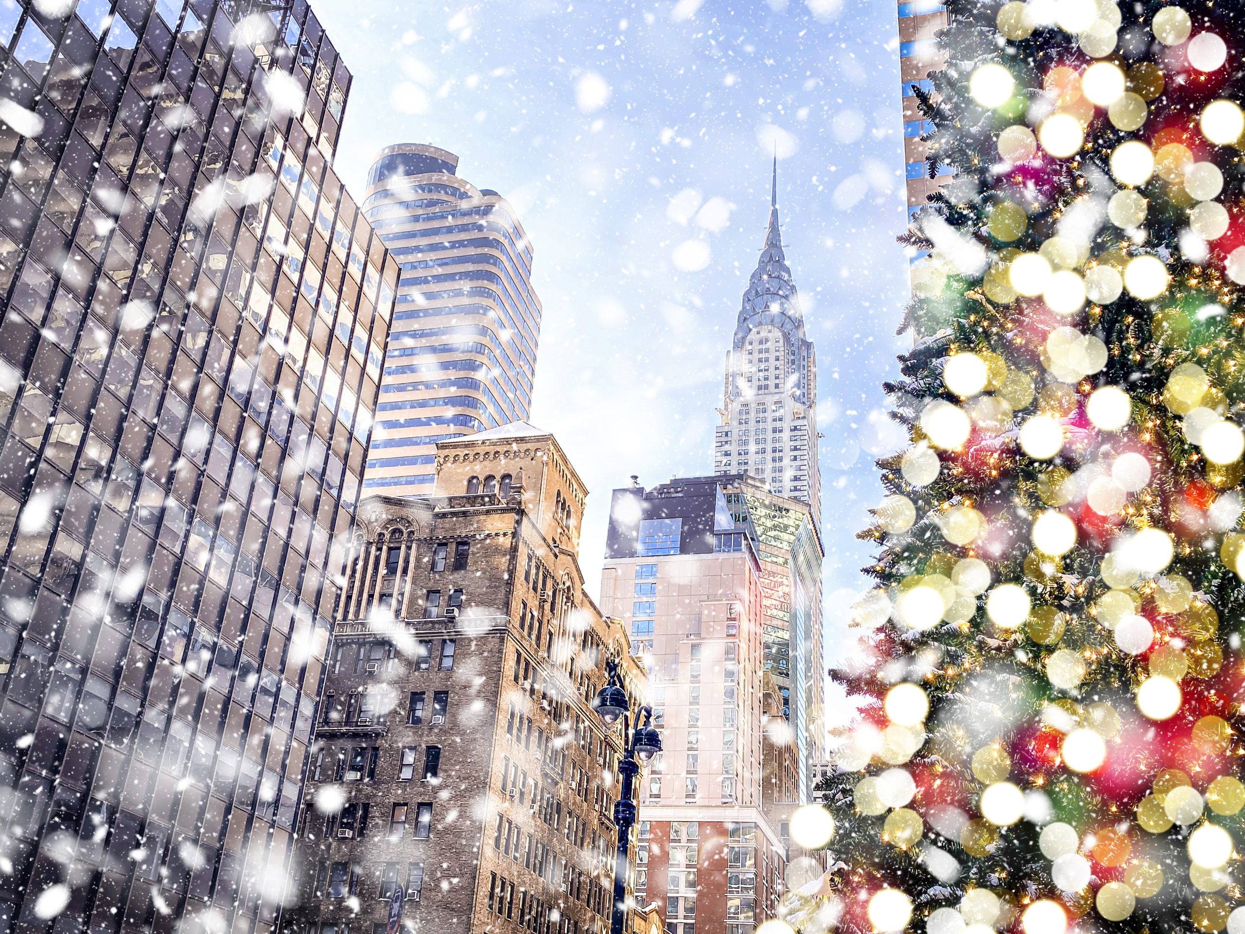 Christmas tree with a snowy New York City in the background