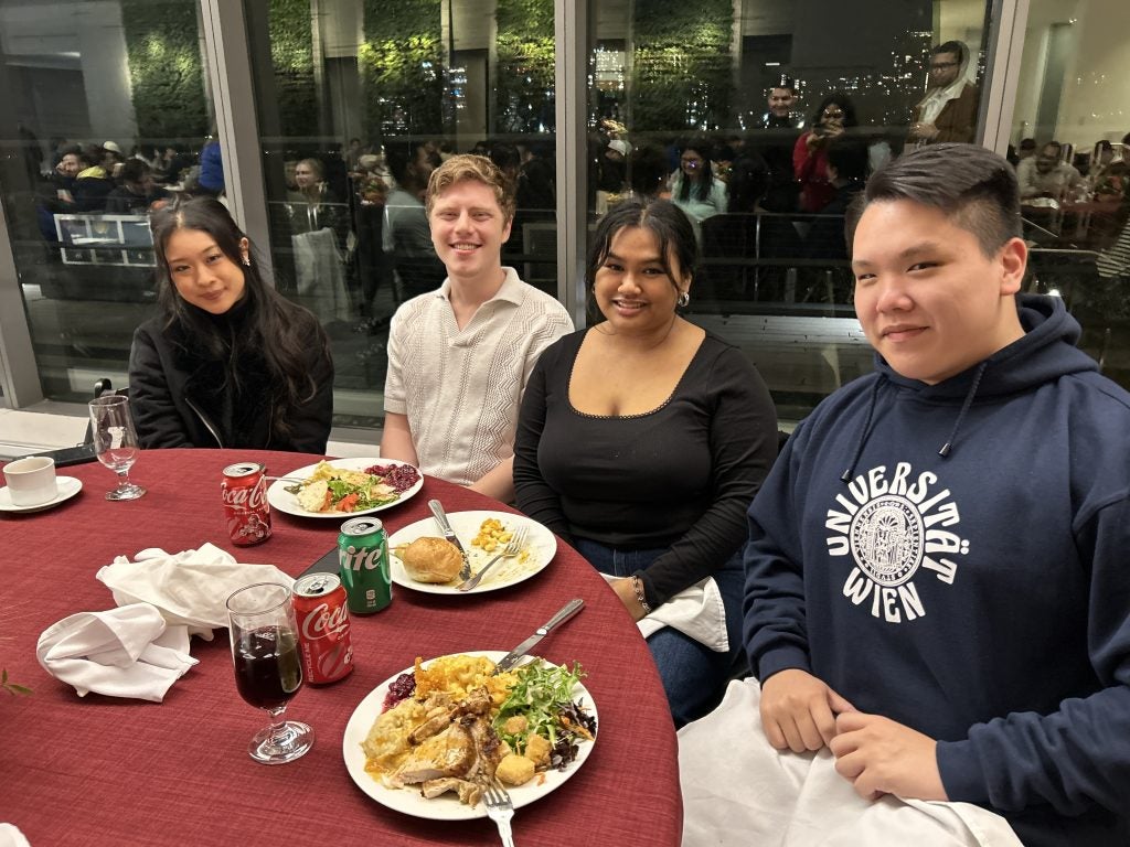 Four students at a table for Thanksgiving