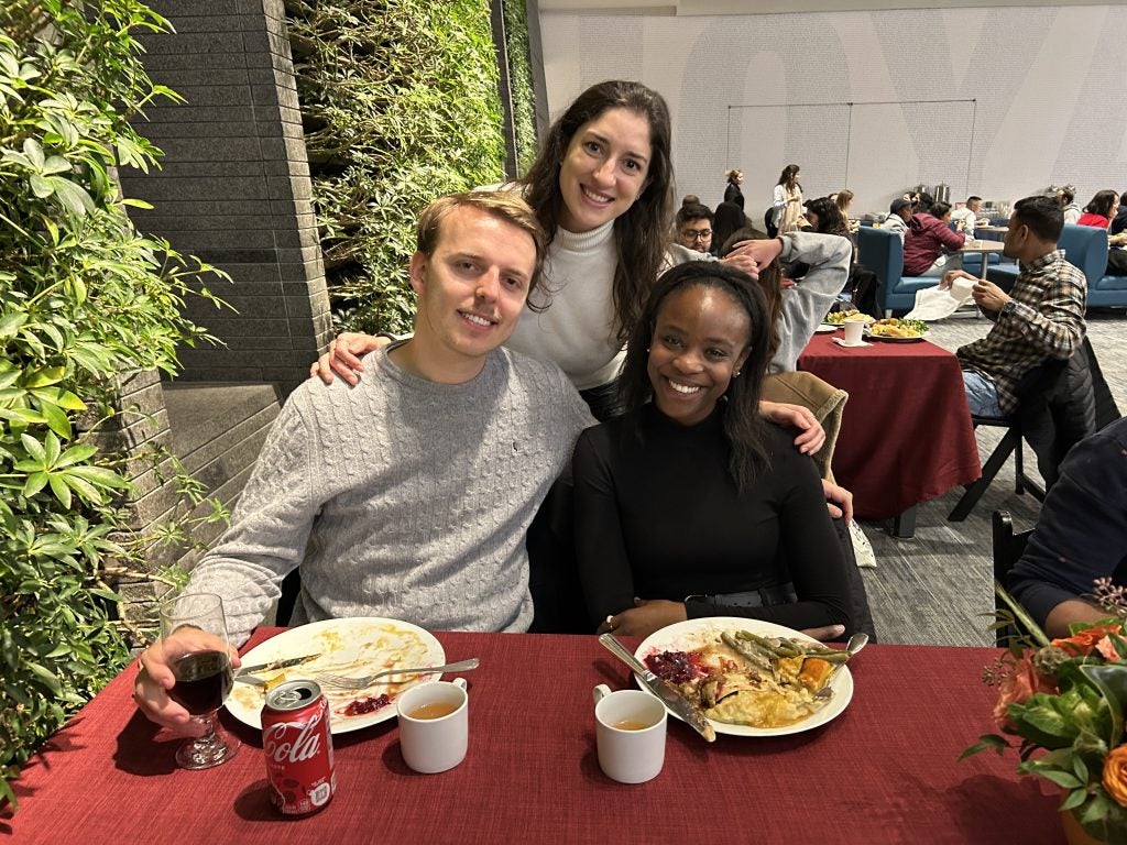 Three students at a table for Thanksgiving