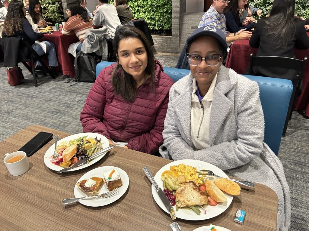 Two young women at a table for Thanksgiving