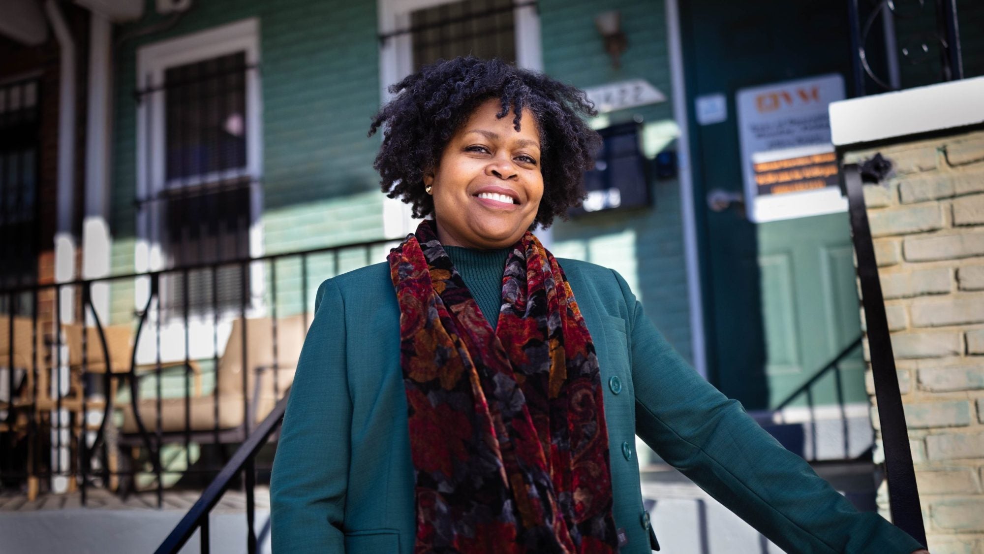 Paula Thompson, CEO and president of Voices for a Second Chance, stands on the steps outside the door to her office&#039;s home-like headquarters.