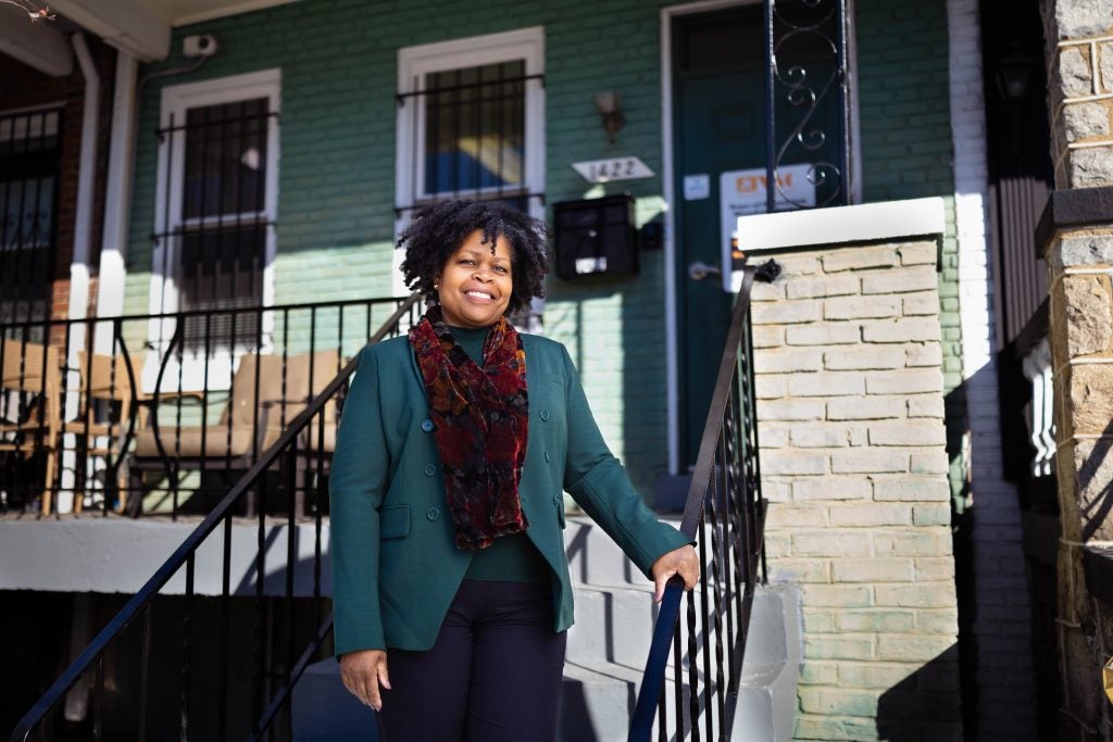 Paula Thompson, CEO and president of Voices for a Second Chance, stands on the steps outside the door to her office's home-like headquarters.