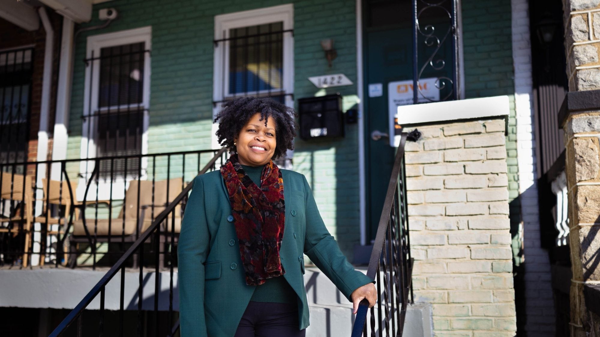 Paula Thompson, CEO and president of Voices for a Second Chance, stands on the steps outside the door to her office&#039;s home-like headquarters.