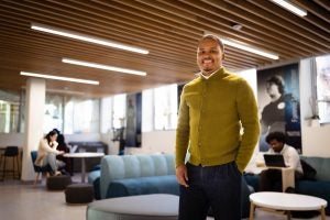 Lionell Daggs standing in the OSEI building during the day