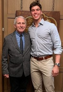 A student poses with Dr. Fauci.