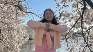 Mara in a pink outfit at the cherry blossoms in DC