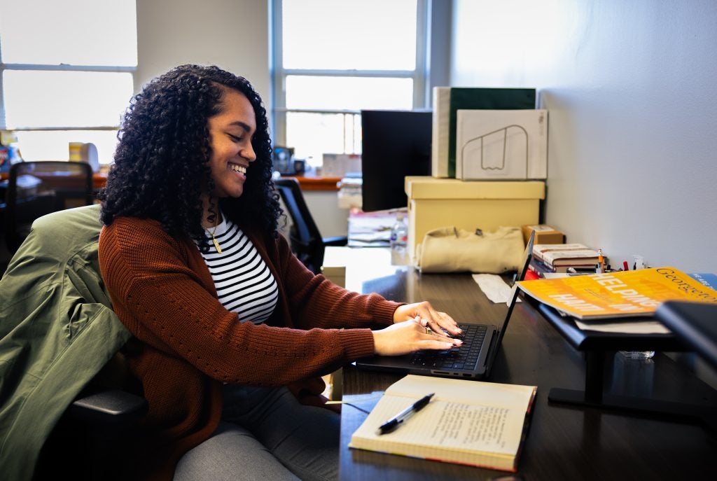 Alexis Green typing at her desk