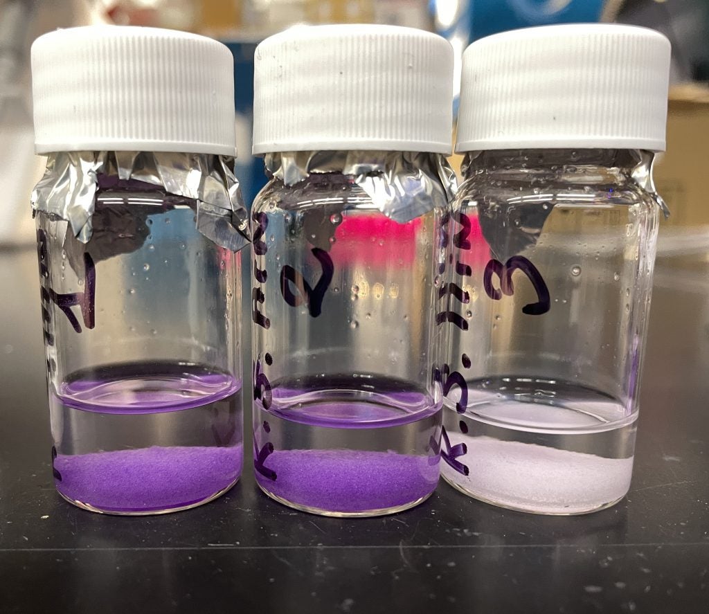 Purple and white salt samples in test tubes