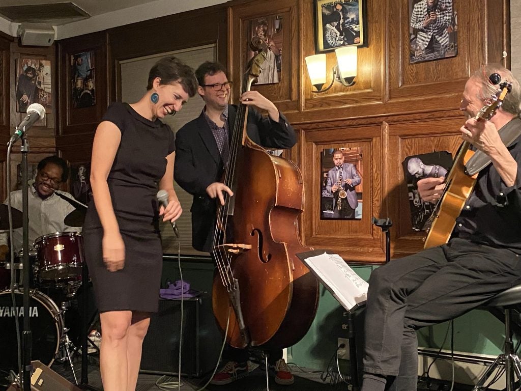 A jazz singer performs on stage.