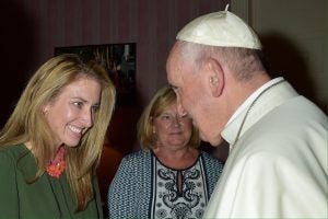 A woman greets Pope Francis smiling