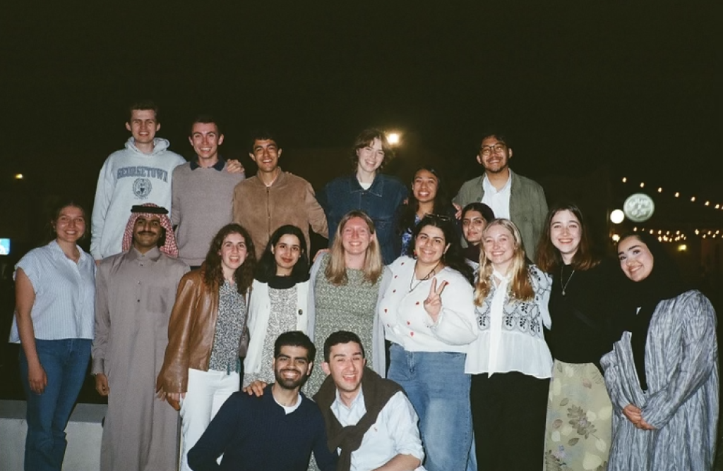 GU students in a group photo at night