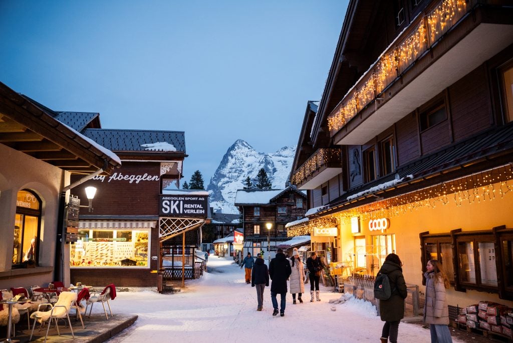 A town in the Swiss Alps at night on a well lit street