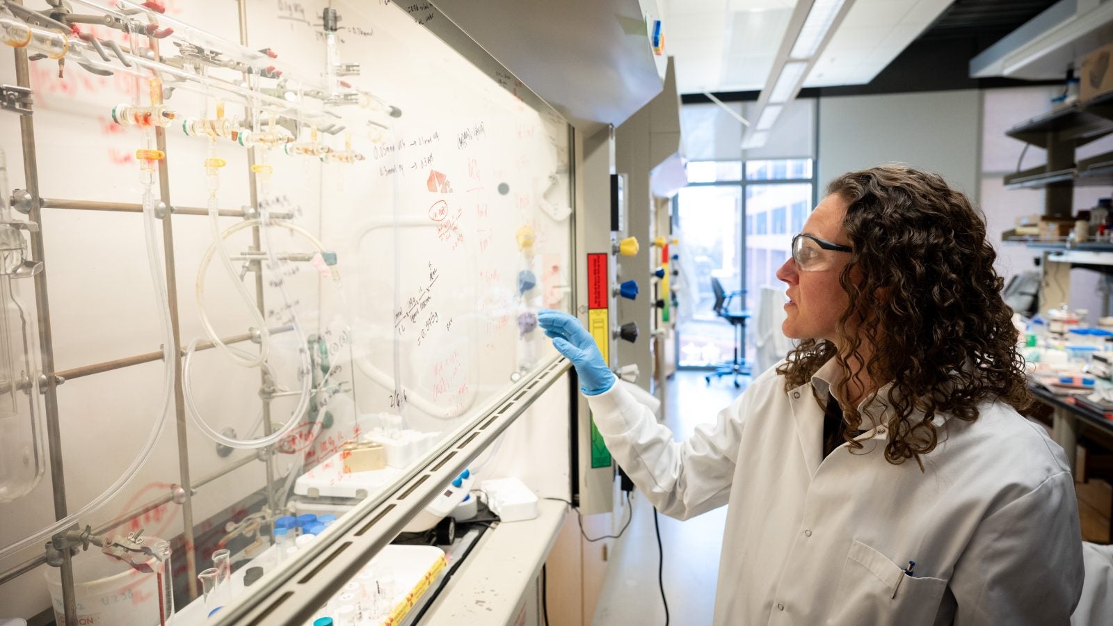 Knope in her chemistry lab in a lab coat