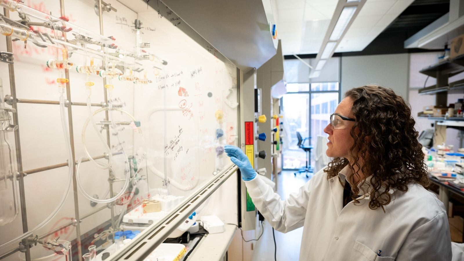 Knope in her chemistry lab in a lab coat