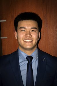 Young Asian men in a dark blue suit and tie