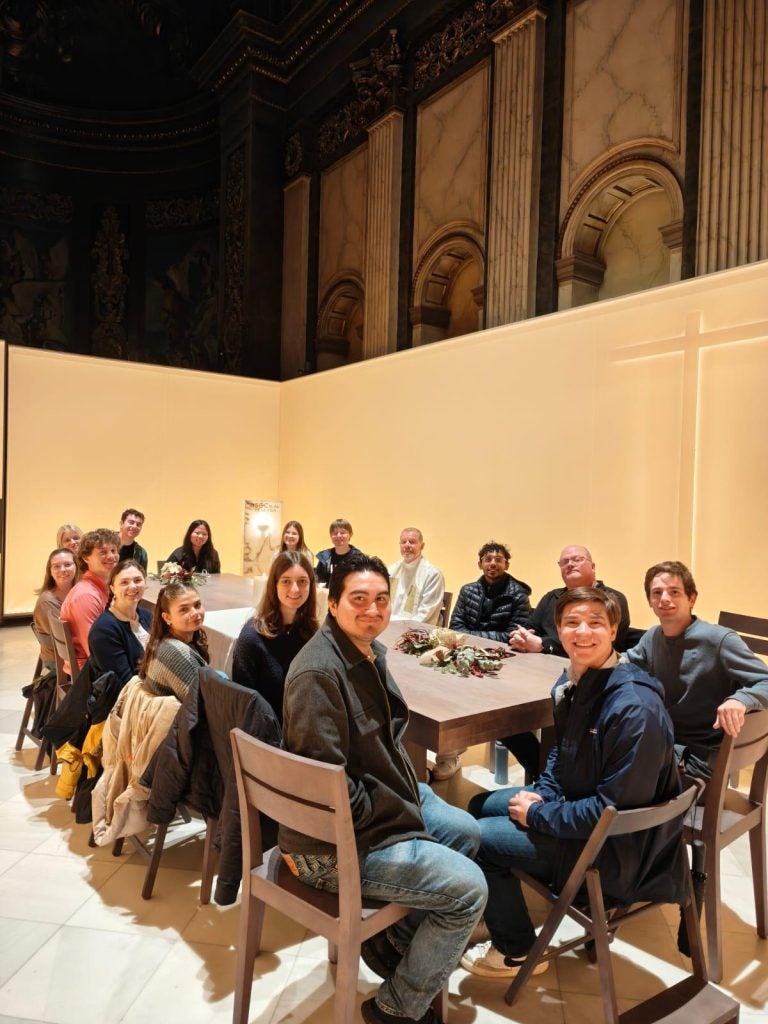 Students sitting around a table inside of a church