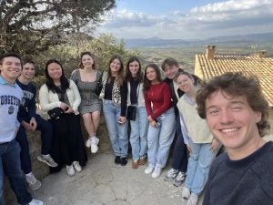 A selfie of students overlooking some plains and mountains in Spain