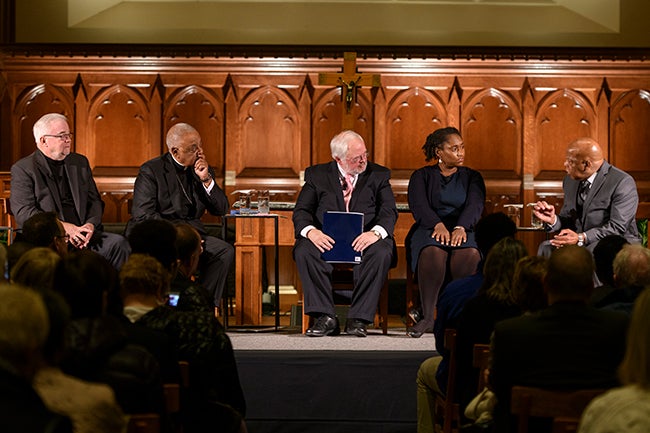 Rev. Jim Wallis, Archbishop Wilton Gregory, John Carr, Marcia Chatelain and Rep. John Lewis talk to each other on stage.