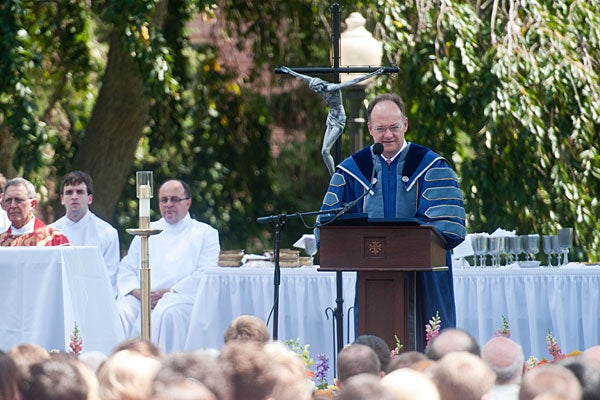 John J. DeGioia speaks at the podium during mass.