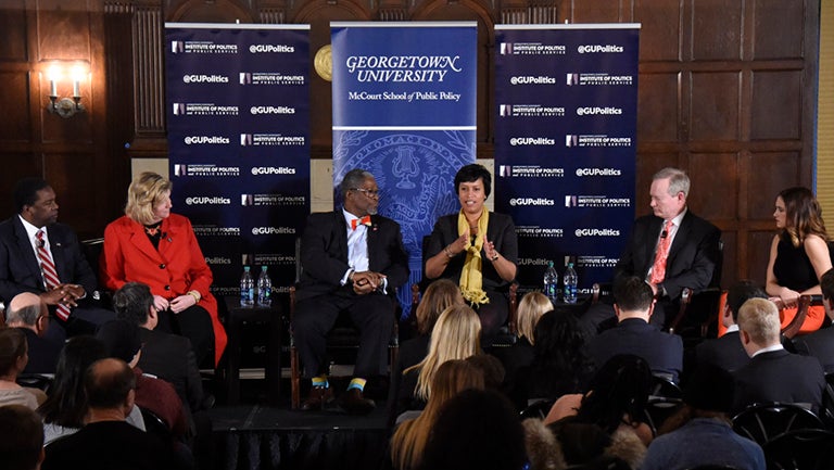 Alvin Brown, Nan Whaley, Sly James, Muriel Boswer, Mick Cornett and Erin Mullally sit while speaking in Copley Formal Lounge