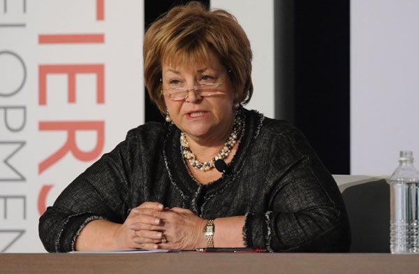 Johanna Mendelson Forman speaks while seated in front of a backdrop