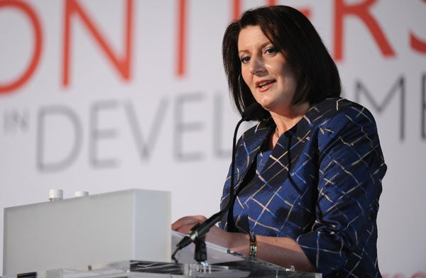 Atifete Jahjaga speaks while seated in front of a backdrop