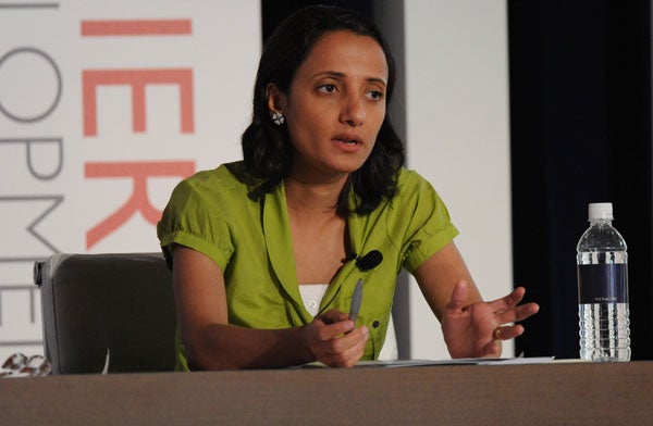 Nadwa Al-Dawsari speaks while seated in front of a backdrop