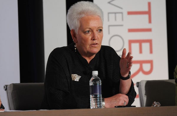 Gayle Smith speaks while seated into a microphone