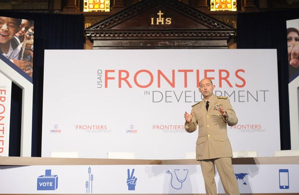 James Stavridis speaks while standing with a microphone