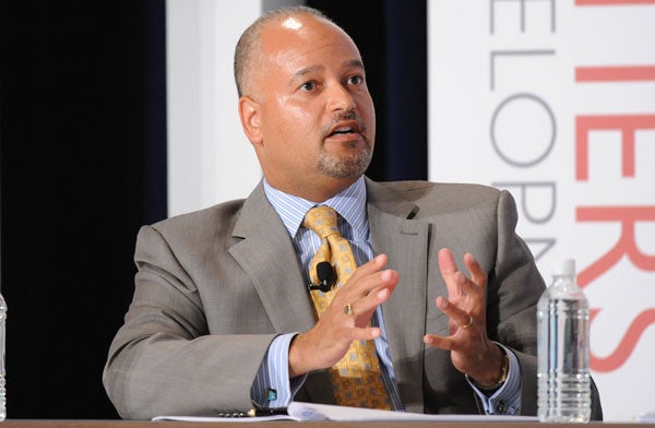 Paul Weisenfeld speaks while seated into a microphone